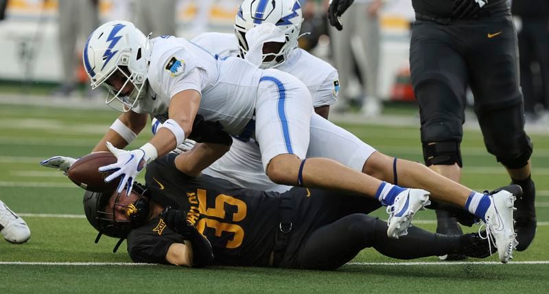 Air Force defensive back Houston Hendrix battles Baylor running back Dawson Pendergrass for a fumble during the first half of an NCAA college football game, Saturday, Sept. 14, 2024, in Waco, Texas. (Rod Aydelotte/Waco Tribune-Herald via AP)