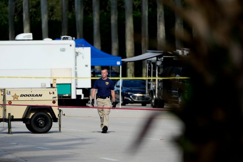 An FBI officer works outside of Trump International Golf Club after the apparent assassination attempt of Republican presidential nominee and former President Donald Trump Monday, Sept. 16, 2024, in West Palm Beach, Fla. (AP Photo/Lynne Sladky)