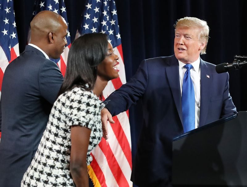 President Donald Trump welcomes business owners Kelvin and Janelle King to the stage to speak during a rally in November 2019. They lead the conservative political action committee Let’s Win For America Action. Curtis Compton/ccompton@ajc.com