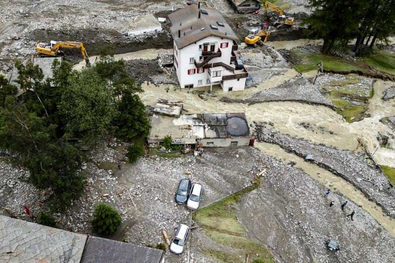 A general view of rubble from a landslide following storms that caused major flooding in Saas-Grund, Switzerland, Sunday, June 30, 2024. Authorities say weekend storms in Switzerland and northern Italy caused extensive flooding and landslides, leaving at least four people dead. Storms and heavy rain affected southern and western Switzerland on Saturday and overnight. (Jean-Christophe Bott/Keystone via AP)