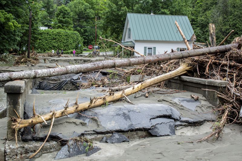 Debris is strewn about a damaged bridge over the Winooski River following flooding caused by the remnants of Hurricane Beryl, Thursday, July 11, 2024, in Plainfield, Vt. (AP Photo/Dmitry Belyakov)