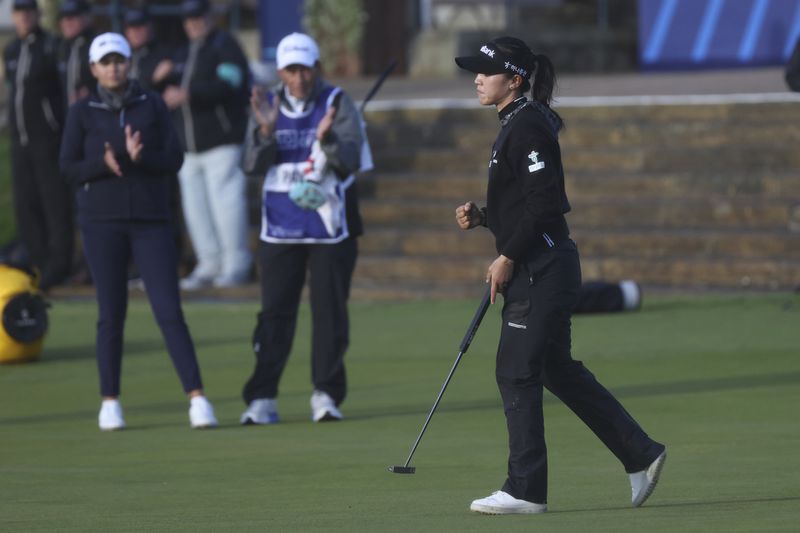 Lydia Ko, of New Zealand, reacts on the 18th green after making a birdie during the final round of the Women's British Open golf championship, in St. Andrews, Scotland, Sunday, Aug. 25, 2024. (AP Photo/Scott Heppell)