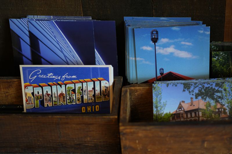 Postcards of Springfield, Ohio, are displayed in the Champion City Guide & Supply, Tuesday, Sept. 17, 2024, in Springfield, Ohio. (AP Photo/Carolyn Kaster)