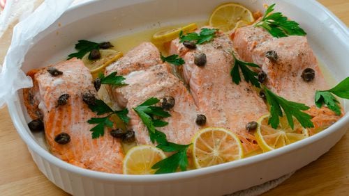 Steamed salmon filets with lemon, butter and capers combine for a classic combination in minutes with the help of a microwave.  / Virginia Willis for the AJC