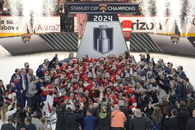 The Florida Panthers team poses with the Stanley Cup trophy after defeating the Edmonton Oilers in Game 7 of the NHL hockey Stanley Cup Final, Monday, June 24, 2024, in Sunrise, Fla. The Panthers defeated the Oilers 2-1. (AP Photo/Rebecca Blackwell)