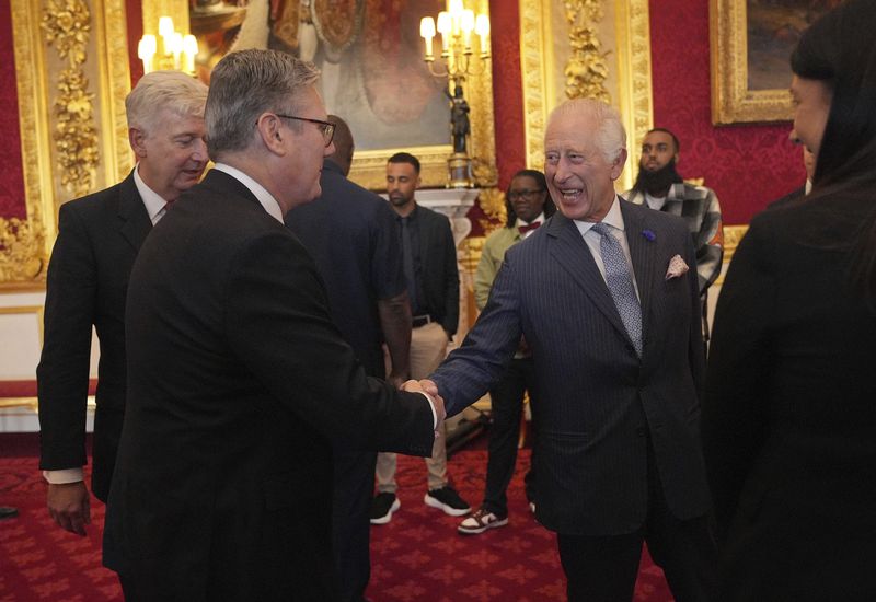 King Charles III greets Prime Minister Sir Keir Starmer at an event for The King's Trust to discuss youth opportunity, at St James's Palace in central London, Friday July 12, 2024. The King and Mr Elba, an alumnus of The King's Trust (formerly known as The Prince's Trust), are meeting about the charity's ongoing work to support young people, and creating positive opportunities and initiatives which might help address youth violence in the UK, as well as the collaboration in Sierra Leone between the Prince's Trust International and the Elba Hope Foundation. (Yui Mok/pool photo via AP)