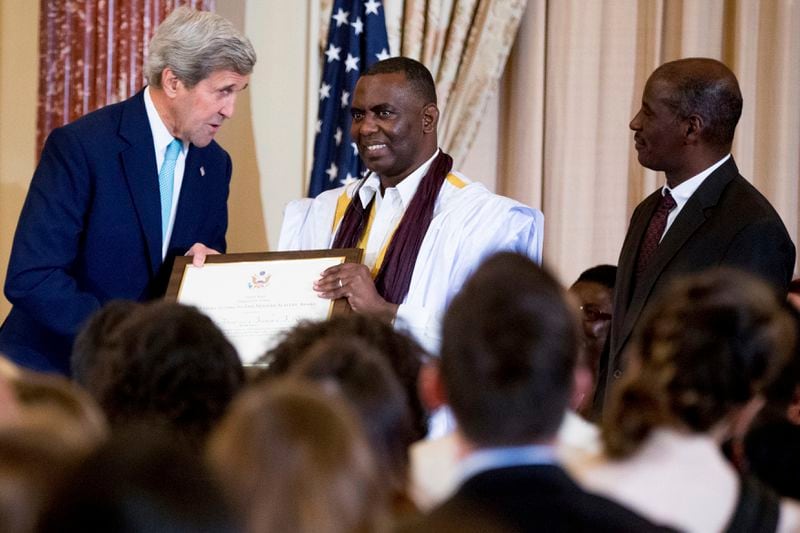 FILE - Secretary of State John Kerry stands with Biram Dah Abeid, center, and Brahim Bilal Ramdhane, right, of Mauritania as they are recognized as "2016 Trafficking in Persons Report" heroes, whose efforts have made an impact on the global fight against modern slavery, June 30, 2016, in Washington. Almost two million people go to the polls on Saturday, June 29, 2024 in Mauritania, a vast desert nation in West Africa. The outgoing President Mohamed Ould Ghazouani, a former army chief and the current head of the African Union, who came to power in 2019 following the first democratic transition in the country’s history, faces seven opponents, among them Biram Dah Abeid, an anti-slavery activist who is a candidate for the third consecutive time, leaders of several opposition parties and a neurosurgeon. (AP Photo/Andrew Harnik, File)