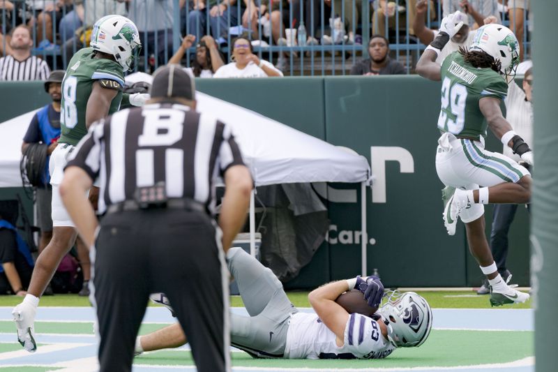 Kansas State tight end Will Swanson (83) comes down with a touchdown catch against Tulane safety Jack Tchienchou (29) during the first half of an NCAA college football game in New Orleans, Saturday, Sept. 7, 2024. (AP Photo/Matthew Hinton)