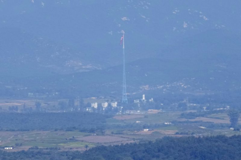 A North Korean flag flutters in the wind atop a 160-meter (525-foot) tower in the North's Kijong-dong village near the truce village of Panmunjom, seen from Paju, South Korea, near the border with North Korea, Friday, Oct. 4, 2024. (AP Photo/Lee Jin-man)