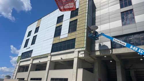 Construction crews were busy Tuesday installing panels to the back side of the South grandstands at UGA's Sanford Stadium, facing Field Street. That work represents some the finishing touches Georgia is hoping gets completed before the Bulldogs play the home opener there on Sept. 7.  (Photo by Chip Towers/ctowers@ajc.com)