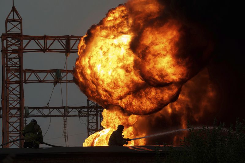 Rescue workers extinguish a fire of burning electrical substation hit by a Russian bombing in Dnipropetrovsk region, Ukraine, Monday, Sept. 2, 2024. (AP Photo/Evgeniy Maloletka)