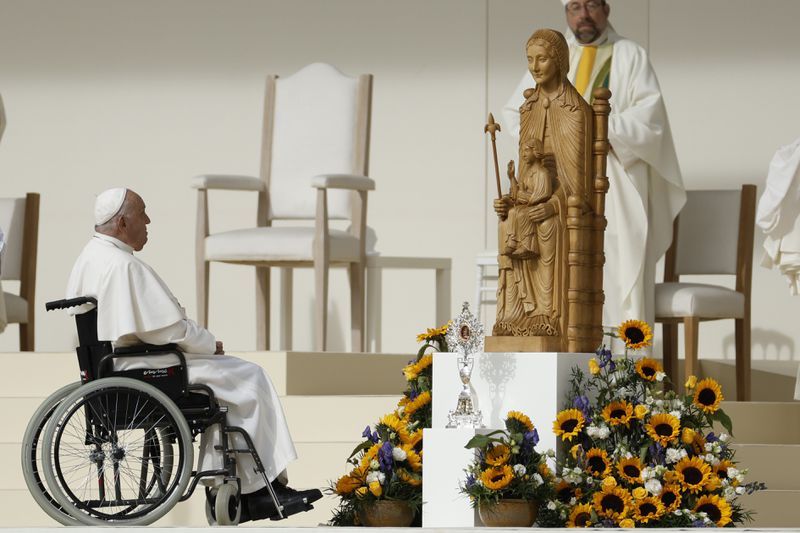 Pope Francis sits on his wheelchair as he presides over the Sunday mass at King Baudouin Stadium, in Brussels Sunday, Sept. 29, 2024. (AP Photo/Omar Havana)