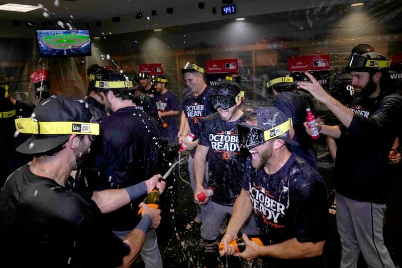 The Detroit Tigers celebrate in the clubhouse after defeating the Houston Astros in Game 2 to clinch the AL Wild Card baseball series, Wednesday, Oct. 2, 2024, in Houston. (AP Photo/Kevin M. Cox)