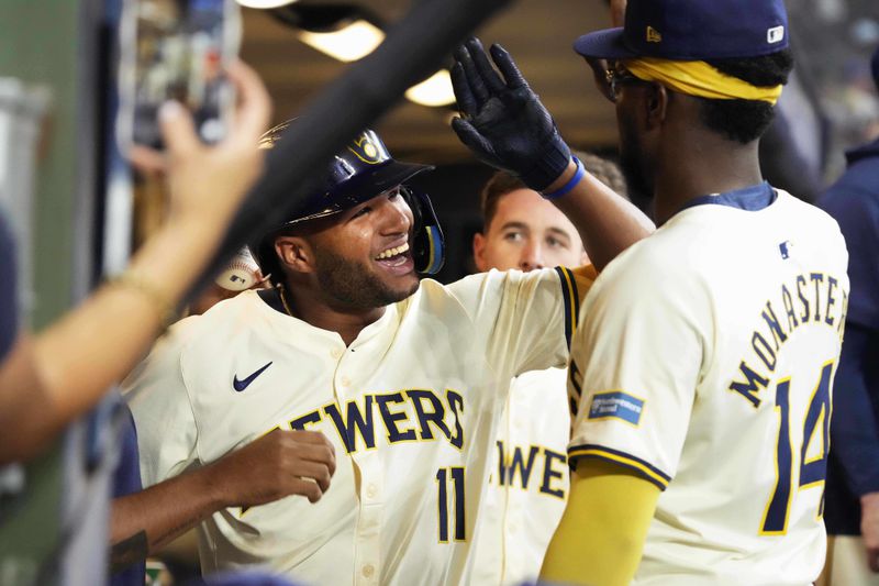 Milwaukee Brewers' Jackson Chourio (11) celebrates in the dugout after hitting a two-run home run in the first inning of a baseball game against the Los Angeles Dodgers, Thursday, Aug. 15, 2024, in Milwaukee. (AP Photo/Kayla Wolf)