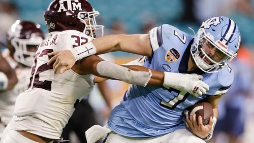 North Carolina quarterback Sam Howell is tackled by Texas A&M's Andre White. Signing day at Georgia Tech did not yield announcements of any new Yellow Jackets, which was an expected result after coach Brent Key and his staff had already brought in (and announced) 19 high school signees and 11 transfers in December and January. (Michael Reaves file photo / TNS)