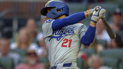 Los Angeles Dodgers' Mookie Betts swings at the pitch in the first inning of a baseball game wearing 21 in commemoration of Roberto Clemente against the the Atlanta Braves, Sunday, Sept. 15, 2024, in Atlanta. (AP Photo/Jason Allen)