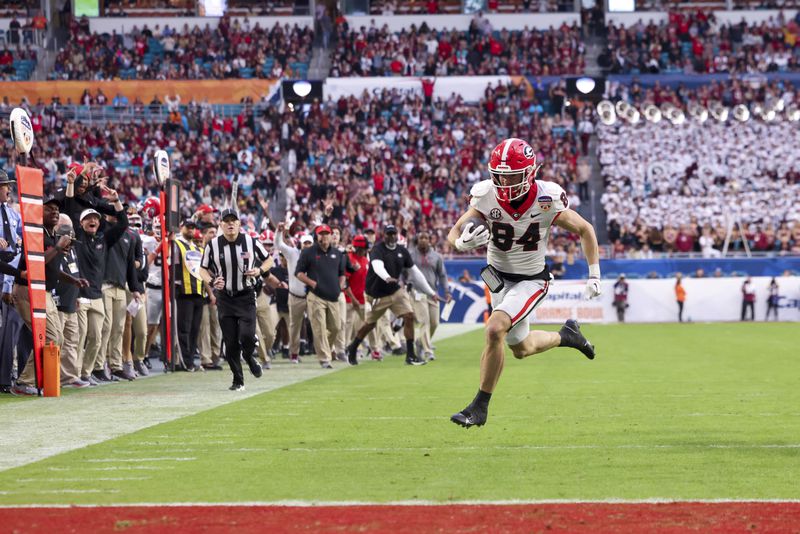 Georgia wide receiver Ladd McConkey (84) rushes for 27-yards for a touchdown during the second quarter against the Florida State in the Orange Bowl at Hard Rock Stadium, Saturday, Dec. 30, 2023, in Miami Gardens, Florida. (Jason Getz / Jason.Getz@ajc.com)