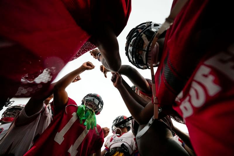 Members of the Baker High football team huddle at practice in Baker, La., Wednesday, Aug. 28, 2024. (AP Photo/Gerald Herbert)