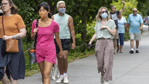 Madeline Raskay, right, and Aldany Diaz, third from left, wear face masks while walking along the Atlanta BeltLine in Atlanta’s Old Fourth Ward community, Friday, May 14, 2021. Both of them say they are fully vaccinated but still prefer to wear face masks in while out in public. (Alyssa Pointer / Alyssa.Pointer@ajc.com)