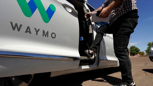 FILE - A Waymo minivan arrives to pick up passengers for an autonomous vehicle ride, Wednesday, April 7, 2021, in Mesa, Ariz. (AP Photo/Ross D. Franklin, File)