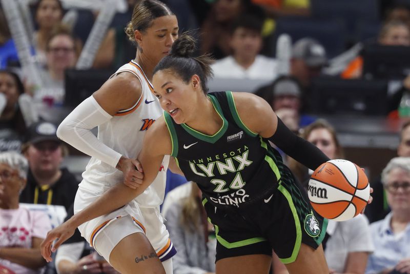 Minnesota Lynx forward Napheesa Collier (24) works around Phoenix Mercury guard Natasha Cloud in the third quarter of Game 2 of a WNBA basketball first-round playoff game Wednesday, Sept. 25, 2024, in Minneapolis. (AP Photo/Bruce Kluckhohn)