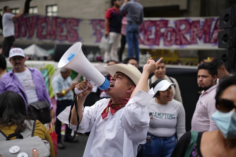 A man shouts uses a bullhorn to shout slogans during a rally in favor of the government's proposed judicial reform outside the Supreme Court building in Mexico City, Thursday, Sept. 5, 2024. (AP Photo/Eduardo Verdugo)