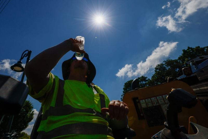 Construction worker Daren True is spotted drinking water as temperatures soared in Metro Atlanta on Monday. The heat indexes are likely to soar past 100 degrees in the next few days.
(Miguel Martinez/AJC)