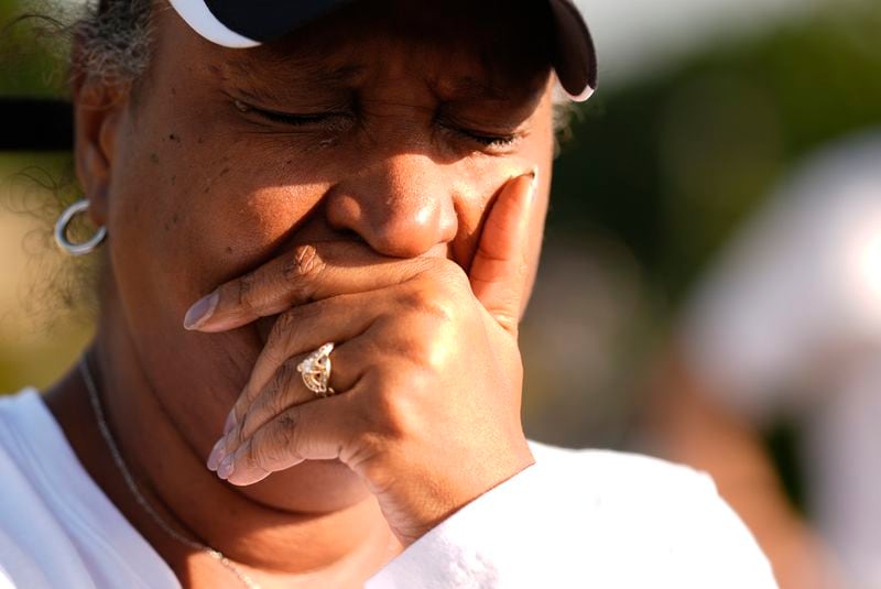 Chimain Douglas, of Grayson, Ga., cries near Apalachee High School as she mourners for the slain students and teachers on Thursday, Sept. 5, 2024, in Winder, Ga. (AP Photo/Brynn Anderson)