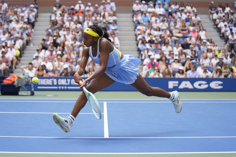 Coco Gauff, of the United States, returns a shot at the net to Varvara Gracheva, of France, during the first round of the U.S. Open tennis championships, Monday, Aug. 26, 2024, in New York. (AP Photo/Seth Wenig)