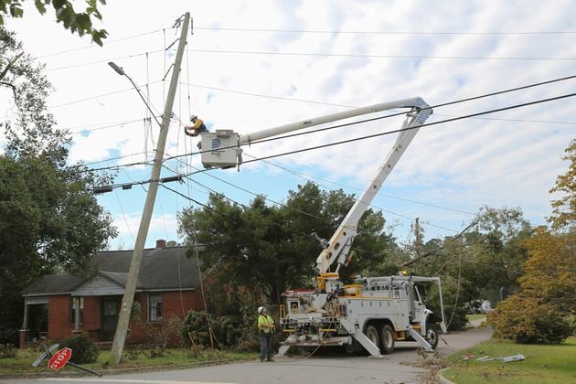 A Dominion Energy lineman works on a power line on Sept. 29 in the aftermath of Hurricane Helene in North Augusta, S.C. (Artie Walker Jr./AP)