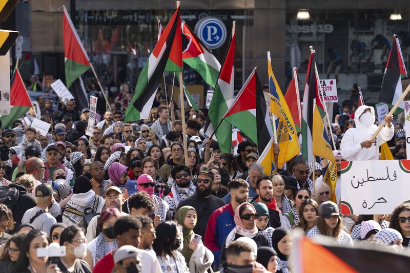 Demonstrators protest in support of the Palestinian people, Saturday, Oct. 5, 2024, in Toronto, days before the one-year anniversary of Hamas' attack in southern Israel and Israel's response to go to war on Hamas. (Arlyn McAdorey/The Canadian Press via AP)