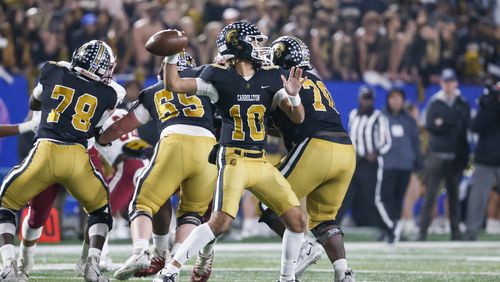 Carrollton quarterback Julian Lewis (10) attempts a pass during the first half against Mill Creek in the GHSA Class 7A finals, at Center Parc Stadium, Saturday, December 10, 2022, in Atlanta. Mill Creek defeated Carrollton 70-35. Carrollton freshman quarterback Julian Lewis threw for a state championship game record 531 yards and five touchdowns. (Jason Getz / Jason.Getz@ajc.com)