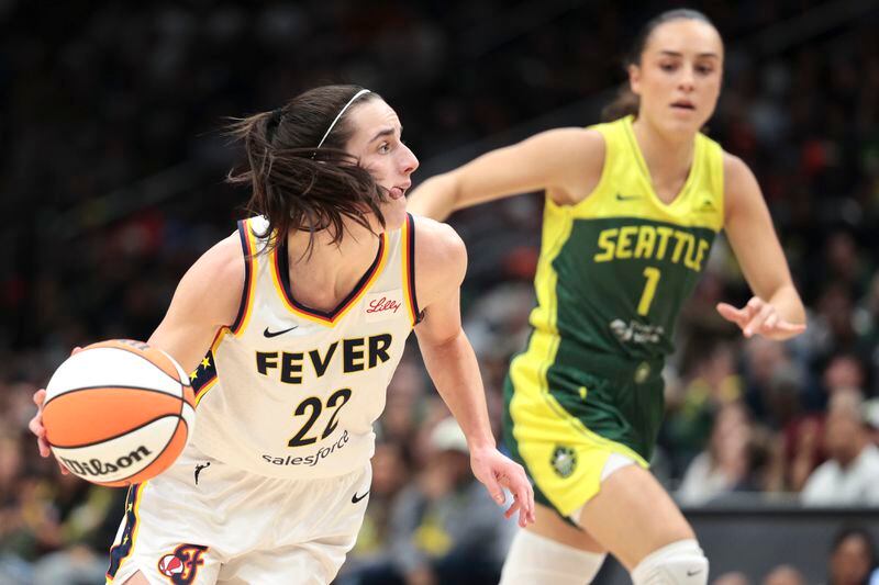 Indiana Fever guard Caitlin Clark (22) drives as Seattle Storm guard Nika Muhl (1) defends during the second half of a WNBA basketball game Wednesday, May 22, 2024, in Seattle. The Storm won 85-83. (AP Photo/Jason Redmond)