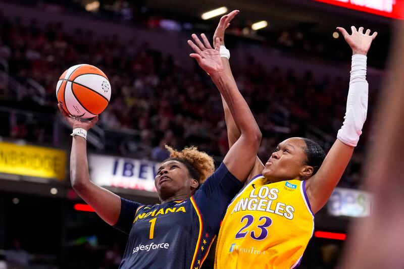 Indiana Fever forward NaLyssa Smith (1) shoots over Los Angeles Sparks forward Azura Stevens (23) in the second half of a WNBA basketball game in Indianapolis, Wednesday, Sept. 4, 2024. (AP Photo/Michael Conroy)