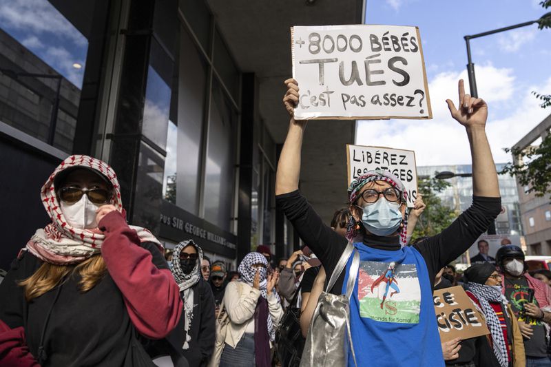 Attendees react during a pro-Palestinian demonstration on the anniversary of a Hamas attack on Israel that triggered the ongoing war in Gaza in front of Concordia University in Montreal, Canada, Monday, Oct. 7, 2024. (Christinne Muschi/The Canadian Press via AP)