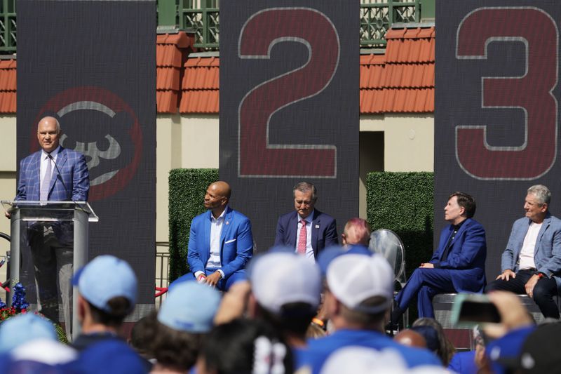 Ryne Sandberg, left, speaks before the Chicago Cubs unveil a statue honoring the legendary Cubs and Hall of Fame player during a dedication ceremony before a baseball game between the New York Mets and the Chicago Cubs in Chicago, Sunday, June 23, 2024. (AP Photo/Nam Y. Huh)