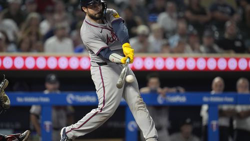 Atlanta Braves' Travis d'Arnaud hits an RBI-single during the 10th inning of a baseball game against the Minnesota Twins, Tuesday, Aug. 27, 2024, in Minneapolis. (AP Photo/Abbie Parr)