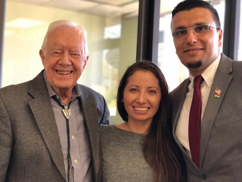 Dr. Heval Kelli and his wife Kazeen pose with former U.S. president Jimmy Carter in 2017.