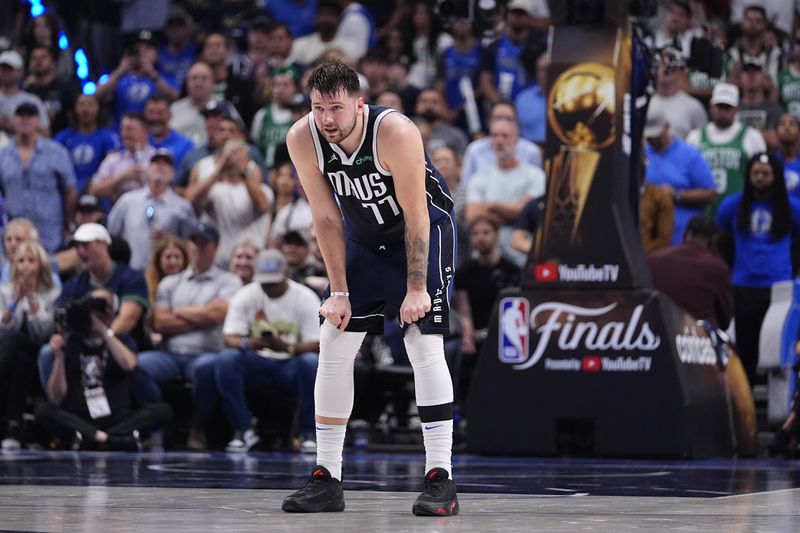 Dallas Mavericks guard Luka Doncic (77) waits for play to resume during the first half in Game 4 of the NBA basketball finals against the Boston Celtics, Friday, June 14, 2024, in Dallas. (AP Photo/Julio Cortez)