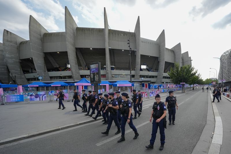 FILE - Police clear the streets outside the stadium ahead of the men's group D match between Israel and Mali at the Parc des Princes during the 2024 Summer Olympics, July 24, 2024, in Paris, France. (AP Photo/Rebecca Blackwell, File )