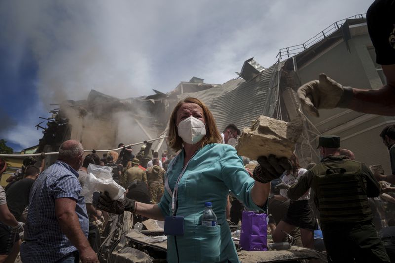 FILE - Emergency workers remove rubble and look for survivors at the site of Okhmatdyt children's hospital hit by Russian missiles, in Kyiv, Ukraine, Monday, July 8, 2024. (AP Photo/Evgeniy Maloletka, File)