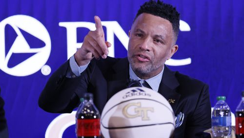 With tears in his eyes, Damon Stoudamire points to acknowledging the presence of his sons Brandon and Damon Stoudamarie Jr during his introduction as the new Georgia Tech coach on Tuesday, March 14, 2023.
Miguel Martinez /miguel.martinezjimenez@ajc.com