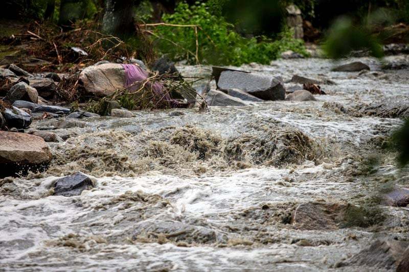 The Winooski River is seen flooded in Plainfield, Vermont. The village was badly hit by the flash flood last night, destroying two bridges and plenty of private houses, Thursday, July 11, 2024. (AP Photo/Dmitry Belyakov)