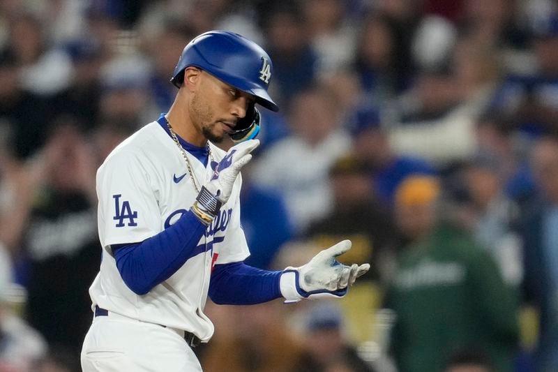 Los Angeles Dodgers' Mookie Betts celebrates after hitting a single during the first inning of a baseball game against the San Diego Padres Thursday, Sept. 26, 2024, in Los Angeles. (AP Photo/Ashley Landis)