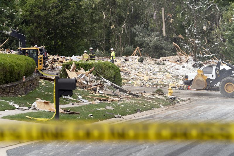 Crew workers remove the debris after a house exploded in Bel Air, Md. neighborhood on Sunday, Aug. 11, 2024. (AP Photo/Jose Luis Magana)