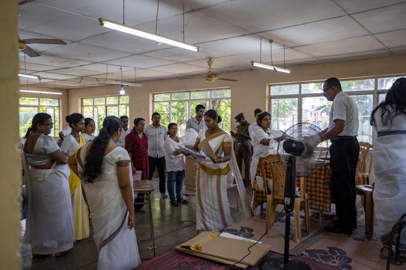 Election officers seal the documents and ballot box at the end of voting during presidential election in Colombo, Sri Lanka, Saturday, Sept. 21, 2024. (AP Photo/Rajesh Kumar Singh)