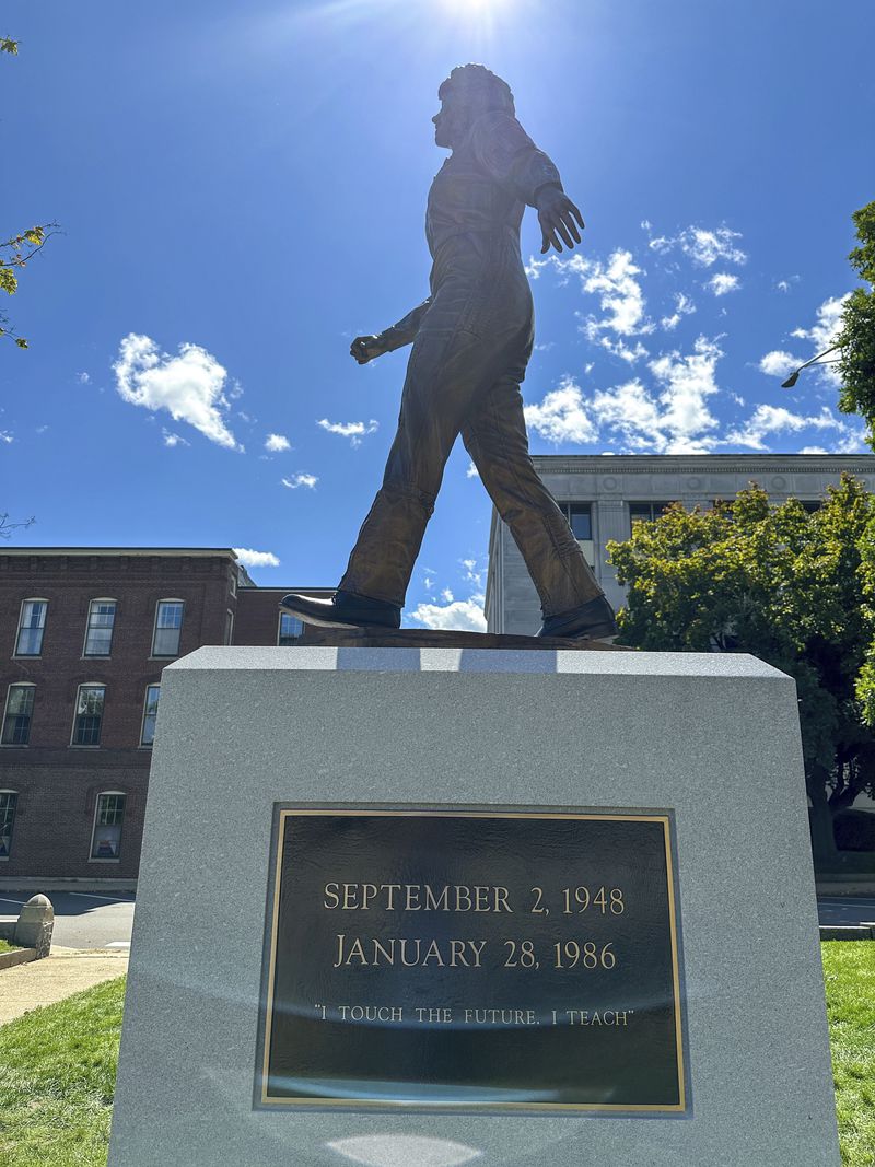 The sun shines on the newly-unveiled statue of Christa McAuliffe at the New Hampshire Statehouse, Monday, Sept. 2, 2024, in Concord, N.H. (AP Photo/Holly Ramer)