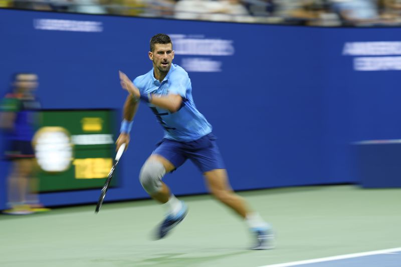 Novak Djokovic, of Serbia, returns a shot to Radu Albot, of Moldova, during a first round match of the U.S. Open tennis championships, Monday, Aug. 26, 2024, in New York. (AP Photo/Matt Rourke)