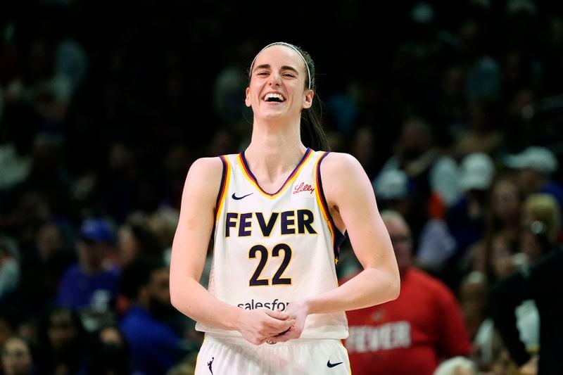 Indiana Fever guard Caitlin Clark laughs as she talks with Phoenix Mercury's Diana Taurasi prior to a WNBA basketball game, Sunday, June 30, 2024, in Phoenix. (AP Photo/Ross D. Franklin)