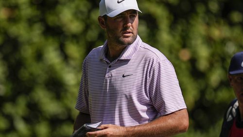 Scottie Scheffler walks off the 11th green during the first round of the Tour Championship golf tournament, Thursday, Aug. 29, 2024, in Atlanta. (AP Photo/Mike Stewart)